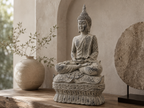 Antique-finish meditating Buddha sculpture styled on a wooden console