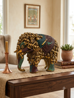Antique gold figural elephant sculpture displayed in a warm home interior