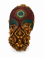 Rear view of elephant sculpture with ornate burgundy and teal saddle