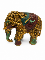 Side view of ornate elephant sculpture with multicolor accents