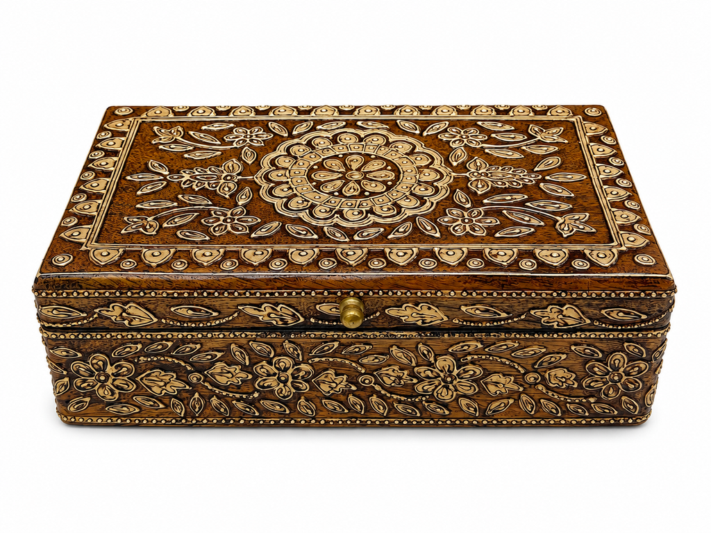Raised front view showing the ornate lid and floral border
