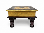 Front view of antique gold embossed puja chowki with turned dark legs