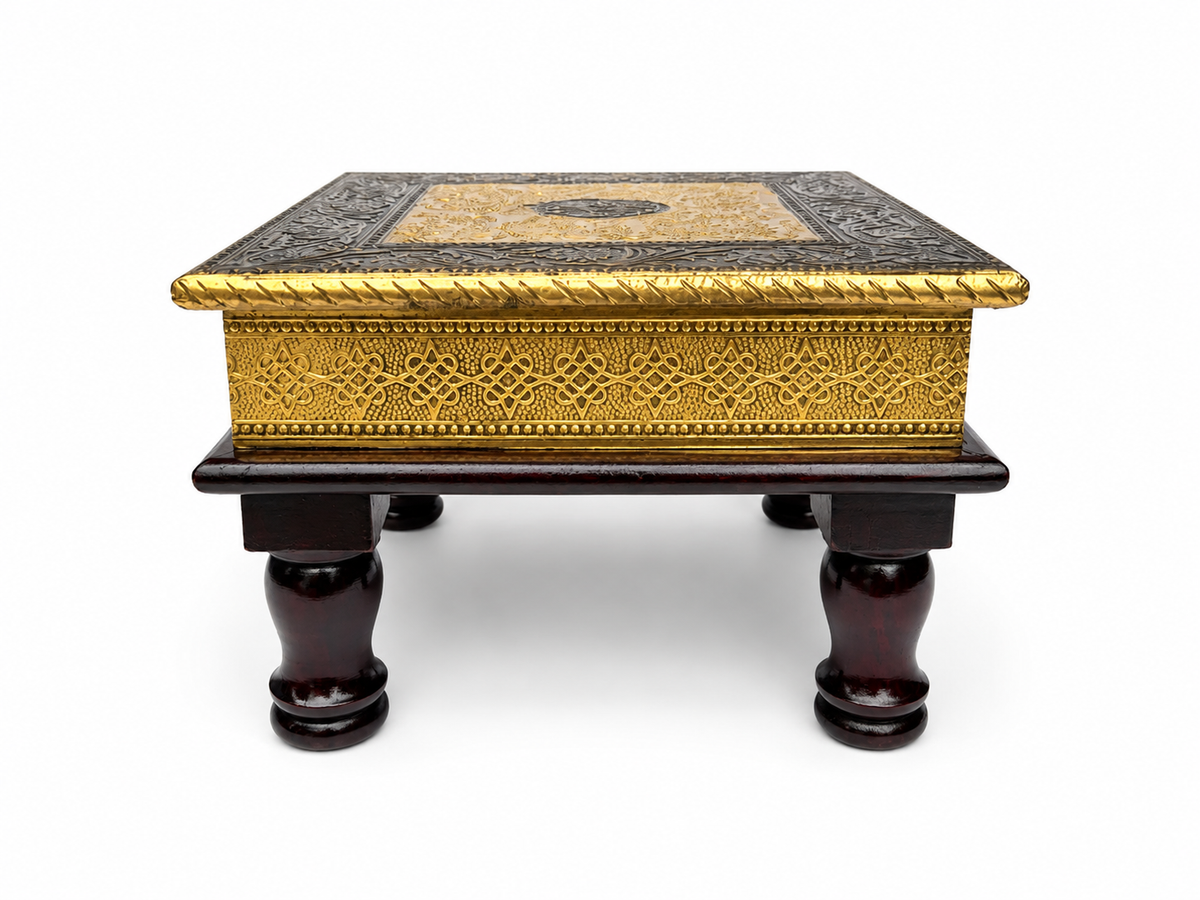 Front view of antique gold embossed puja chowki with turned dark legs