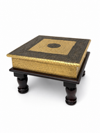 Angled view of antique gold floral embossed puja chowki