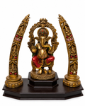 Front view of antique gold Ganesha idol with ornate tusk-style side arches