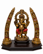 Front view of antique gold Ganesha idol with ornate tusk-style side arches
