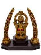 Rear view of antique gold Ganesha idol and ornate decorative arches