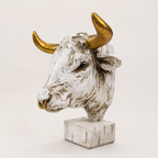 Antique ivory and gold bull head sculpture with nose ring, angled view
