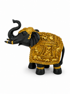 Side view of black and antique gold embossed elephant sculpture with raised trunk