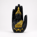 Black and gold Buddha figure framed within a blessing palm sculpture, front view