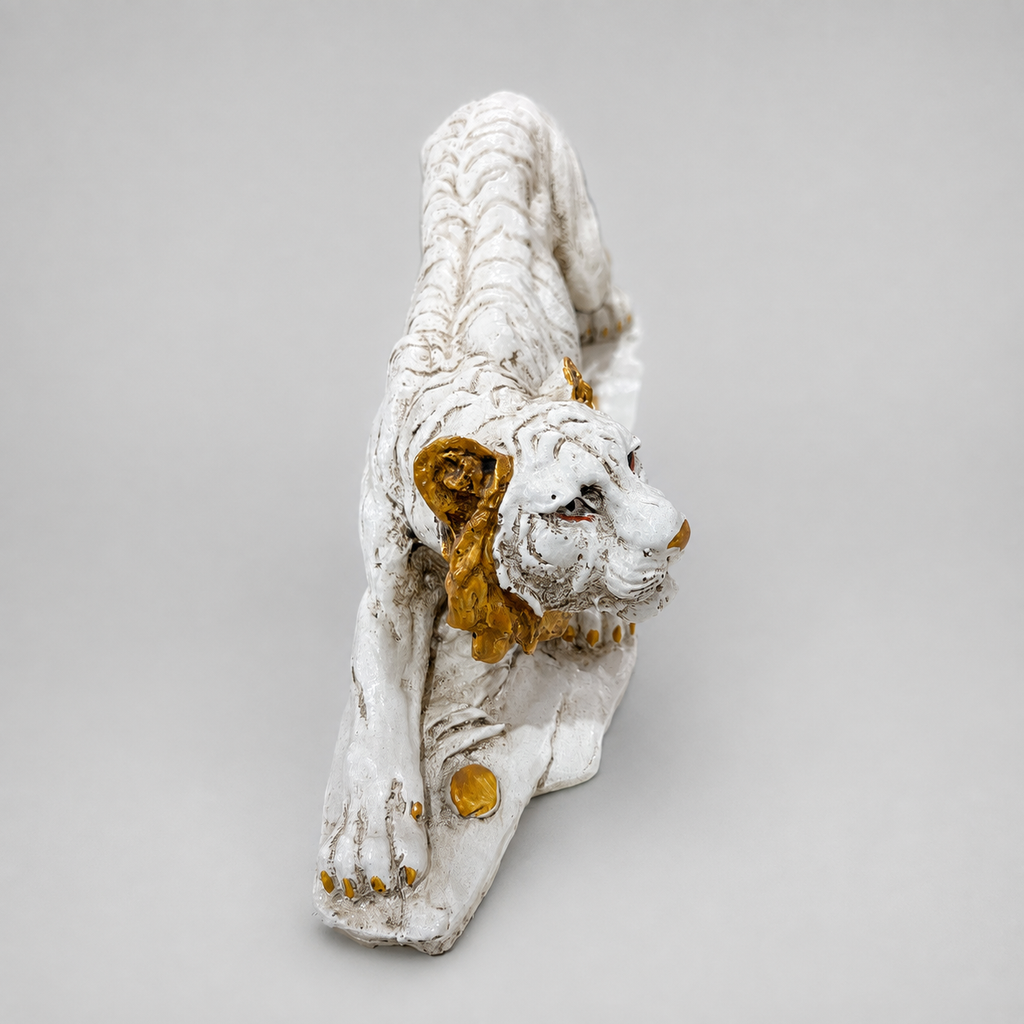 Ivory and gold crouching tiger sculpture, front angled view