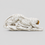 Ivory and gold crouching tiger sculpture on a rocky base, rear profile