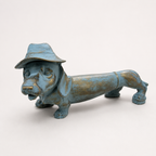 Blue and gold dachshund decorative sculpture wearing a hat, front view