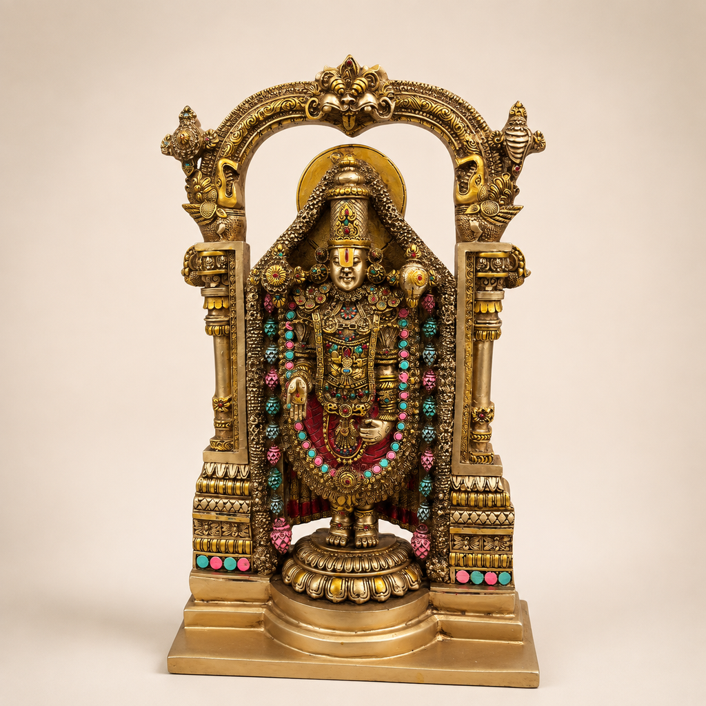 Tirupati Balaji idol beneath an ornate gold-tone temple arch, with colourful garlands and a stepped pedestal, front view