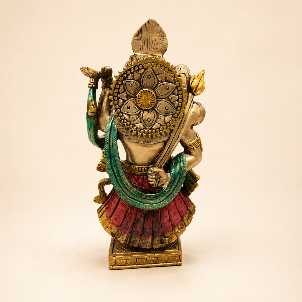 Rear view of the Divine Grace Shrinathji idol showing a floral halo, green drape, red garment and decorated pedestal