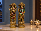 Divine Harmony Radha–Krishna pair on a marble altar beside lit diyas