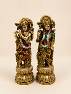 Divine Harmony Radha–Krishna idol pair with an antique gold-tone finish, colourful garlands and lotus-style bases