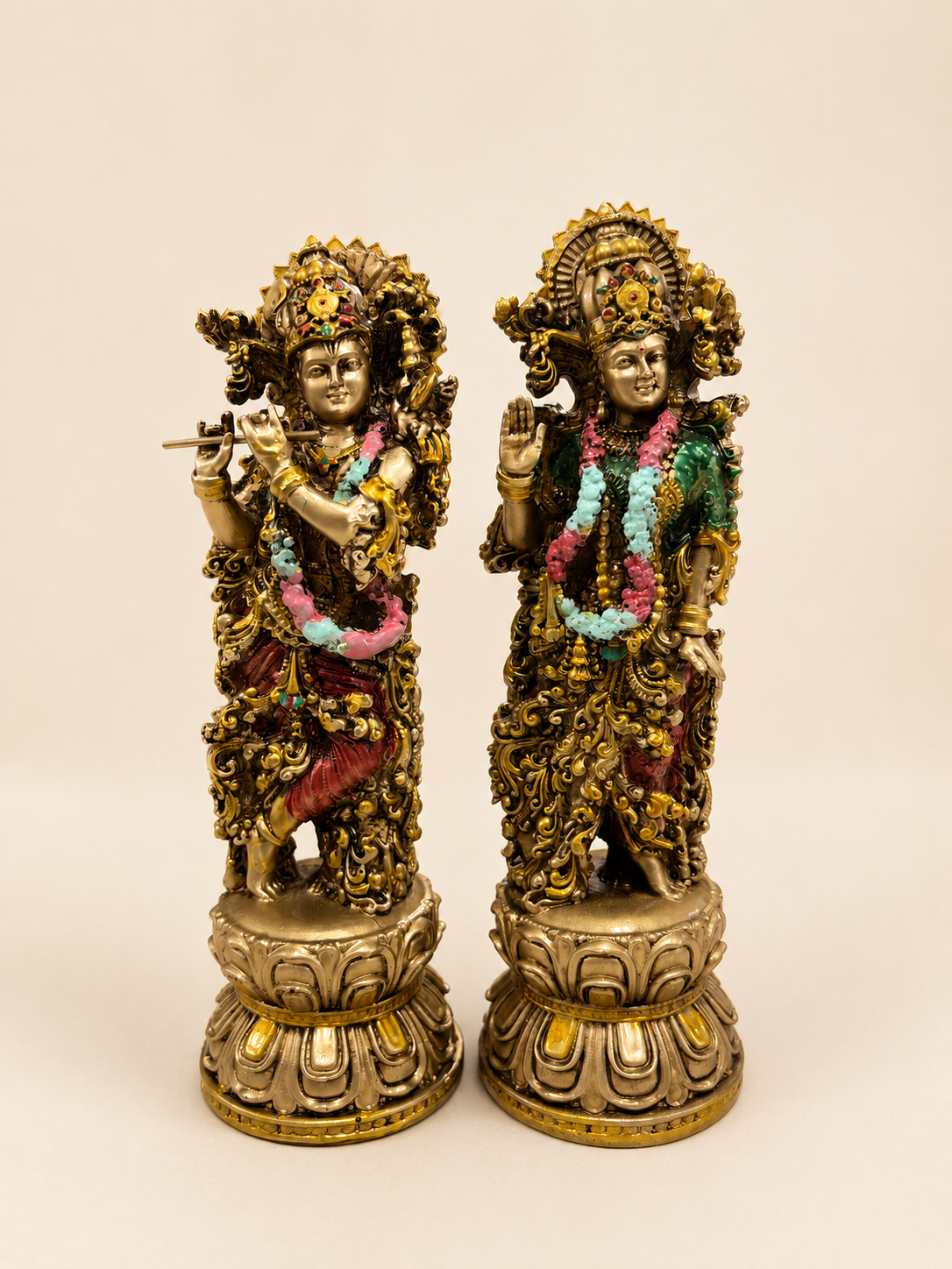 Divine Harmony Radha–Krishna idol pair with an antique gold-tone finish, colourful garlands and lotus-style bases