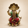 Lord Vishnu seated on a lotus beneath a five-headed serpent canopy, with a gold-tone finish and red and green garments, front view