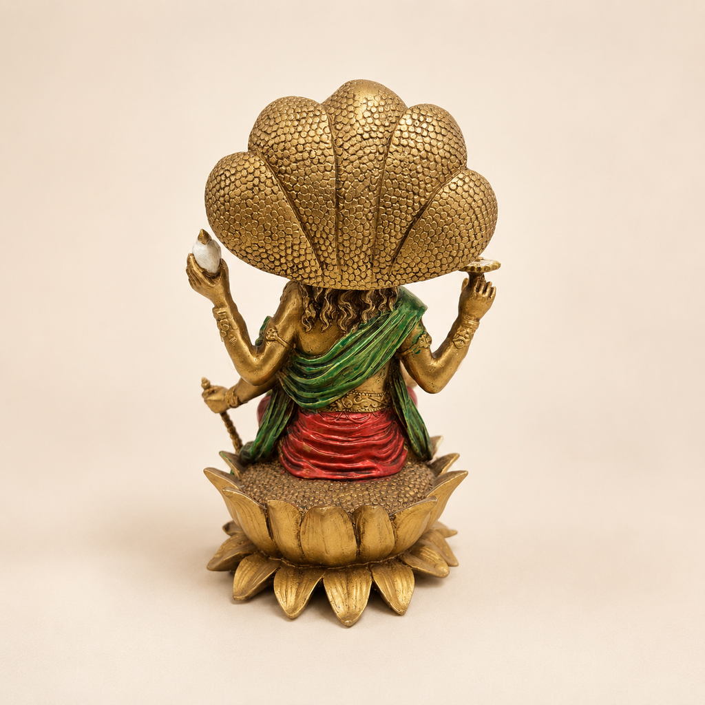 Rear view of the Vishnu idol showing the textured five-headed serpent canopy, green drape and lotus pedestal