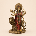 Divine Shakti Durga idol with a lion, red attire, antique gold-tone detailing and a sunburst halo, front view