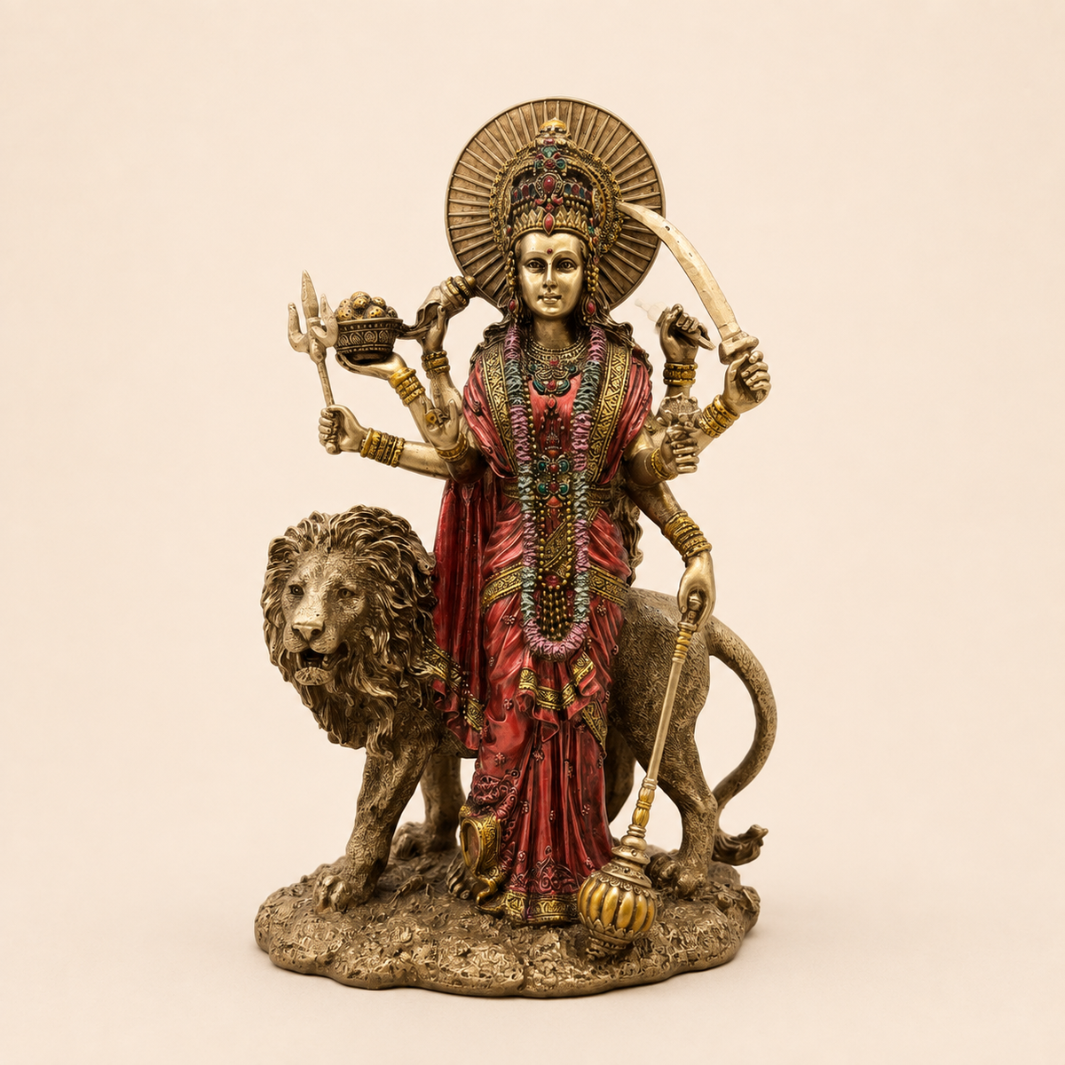 Divine Shakti Durga idol with a lion, red attire, antique gold-tone detailing and a sunburst halo, front view