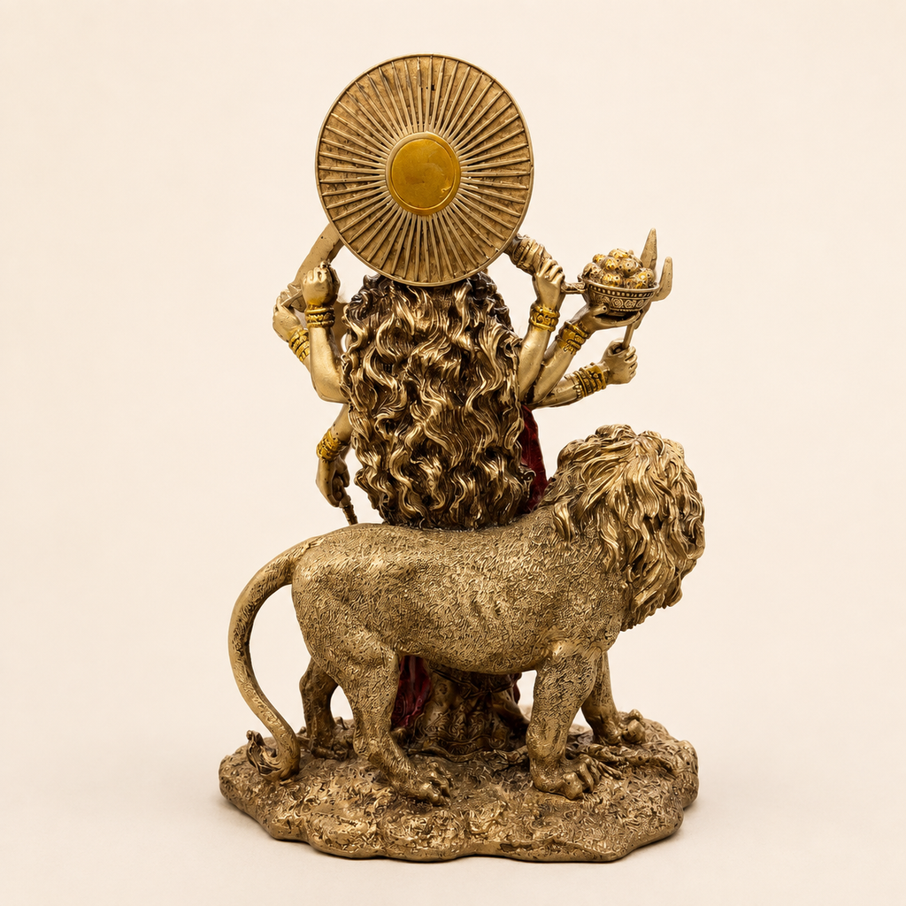 Rear view of the Durga idol with flowing hair, circular sunburst halo and detailed lion
