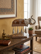 Elephant bell chime table sculpture displayed in a warm home interior