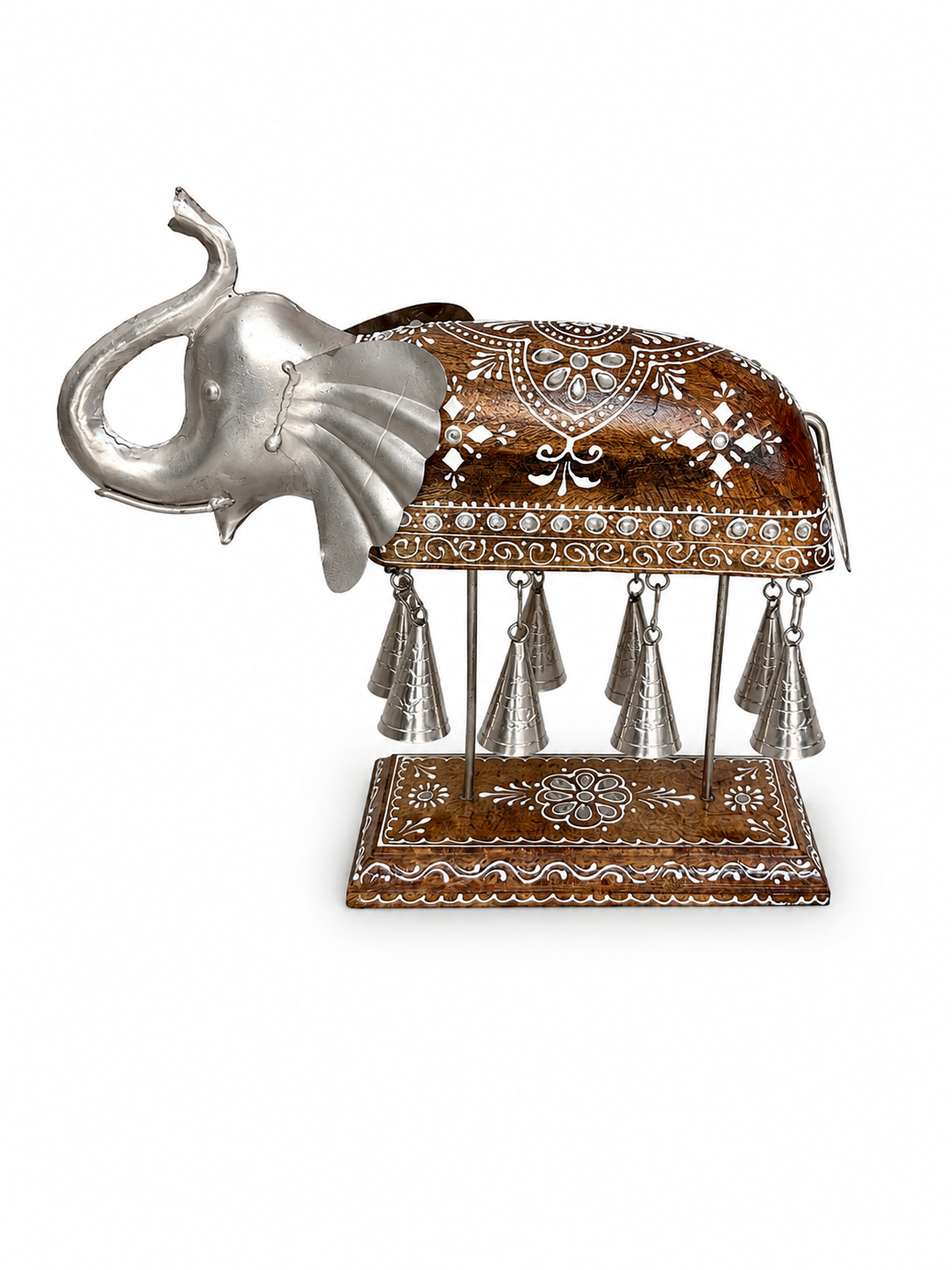 Side view of decorative elephant bell sculpture on patterned base