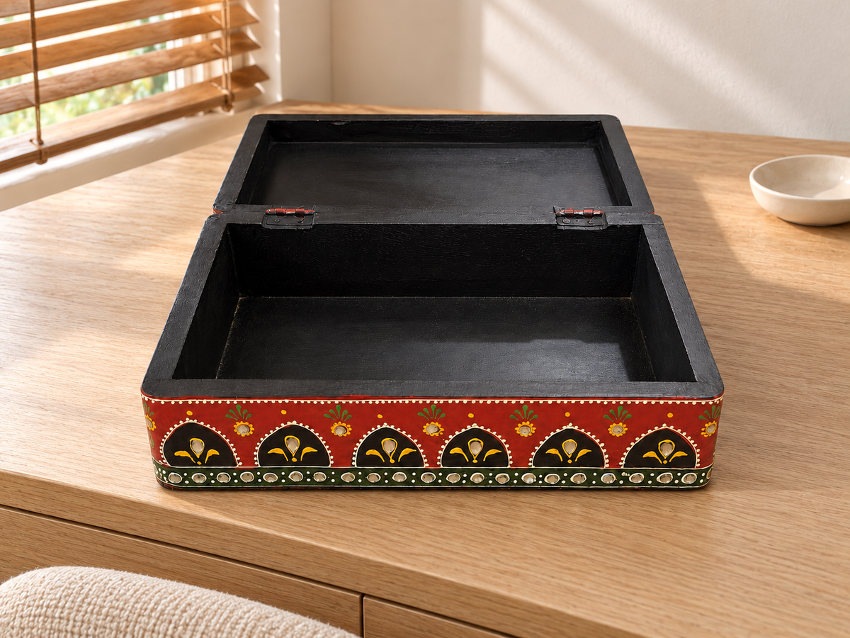 Open Emerald Darbar keepsake box on an oak dresser, showing the black interior