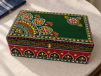 Overhead angled view of Emerald Darbar keepsake box on a pale fabric surface