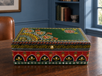 Emerald Darbar keepsake box displayed on a wooden desk in a blue study