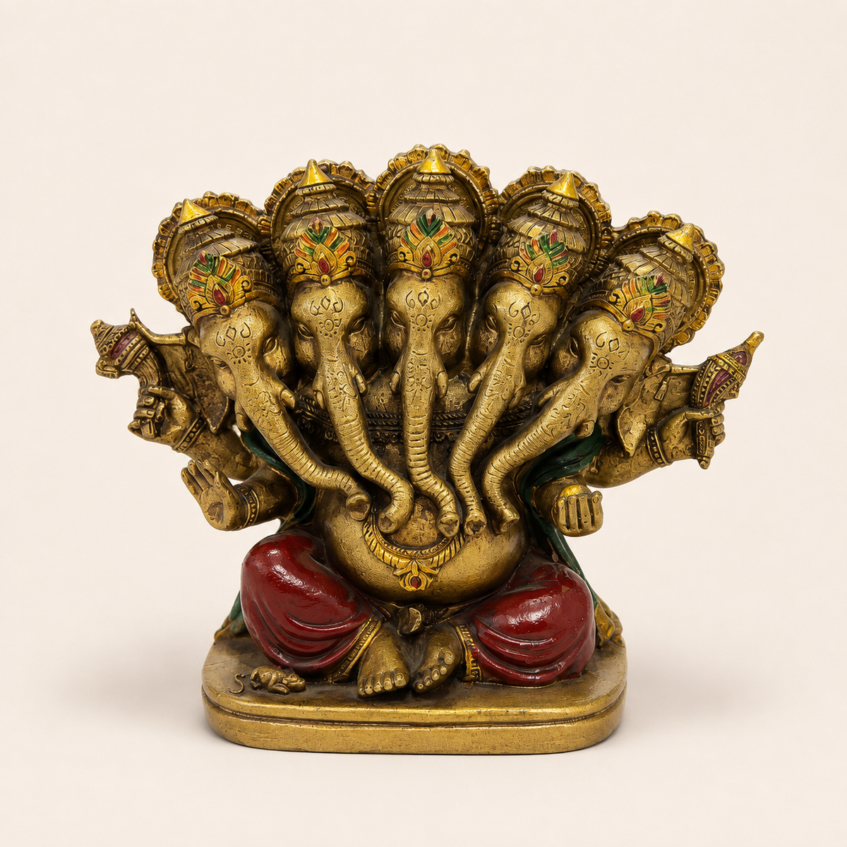 Panchmukhi Ganesha idol with five crowned elephant faces, a gold-tone finish, red clothing and green drape, front view