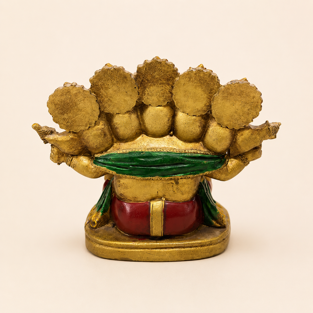 Rear view of the five-faced Ganesha idol showing the crown backs, green drape, red clothing and broad pedestal