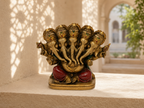 Panchmukhi Ganesha idol displayed on a sandstone shelf in a sunlit interior