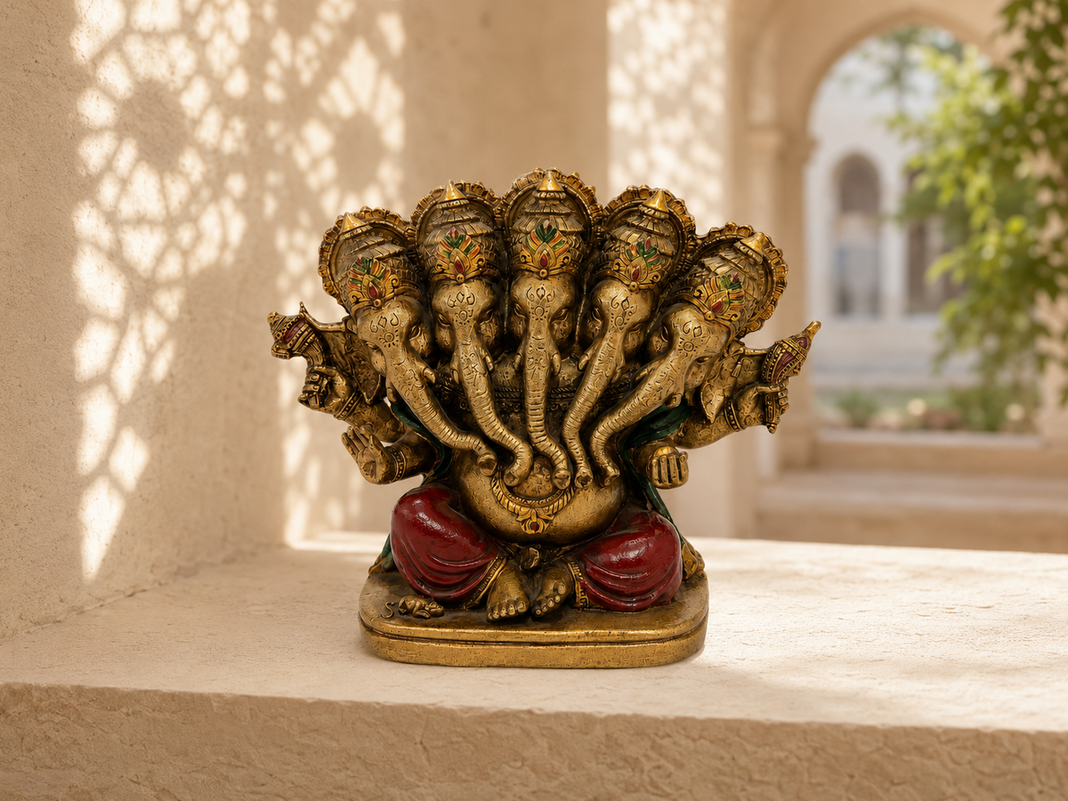 Panchmukhi Ganesha idol displayed on a sandstone shelf in a sunlit interior