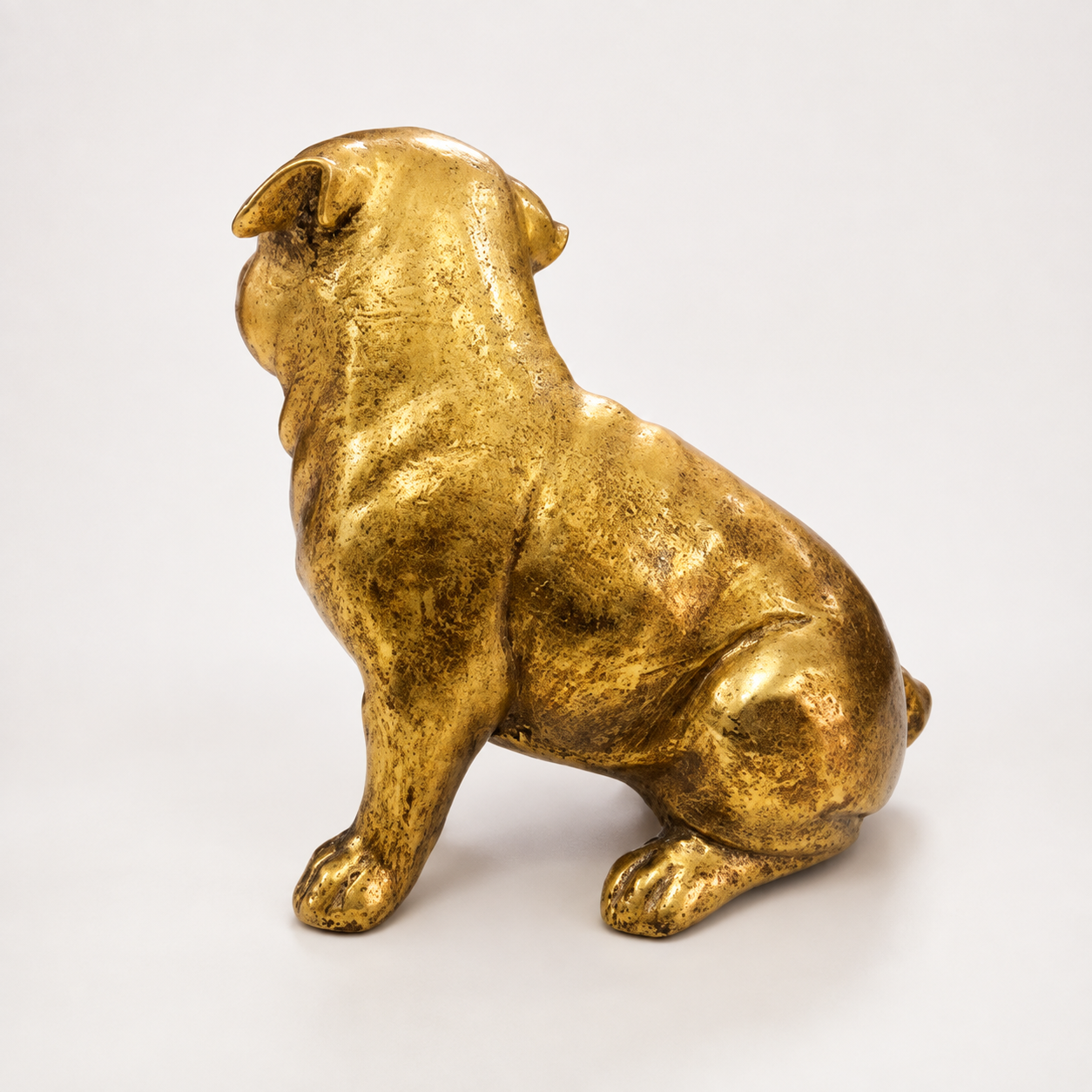 Golden sitting pug decorative sculpture, back view