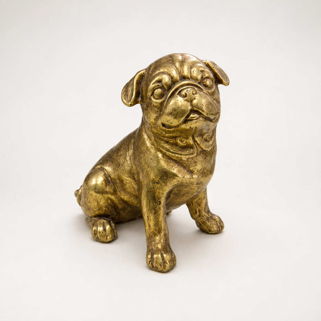 Golden sitting pug decorative sculpture, front view