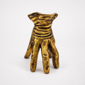 Golden hand-shaped decorative pot, front view