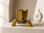 Golden mosaic face sculpture styled in a light neutral interior