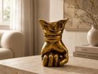Golden Resolve sculpted hand decorative accent styled on a console
