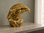 Golden Sentinel eagle bust on a console beside a softly lit window