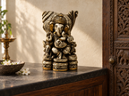 Heritage Grace Ganesha idol on a dark stone altar beside a carved wooden door, lamp and flowers