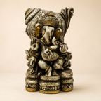Heritage Grace Ganesha idol with an ivory-tone antique-style finish, gold-tone accents and an ornate backdrop, front view