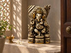 Heritage Grace Ganesha idol on a sunlit stone altar beside a lamp and white flowers