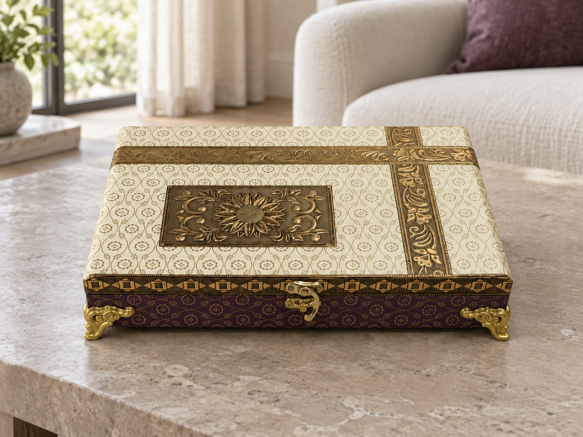 Closed ivory and gold-tone decorative organiser box styled on a living room coffee table