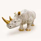 Ivory and gold decorative rhino sculpture, front three-quarter view