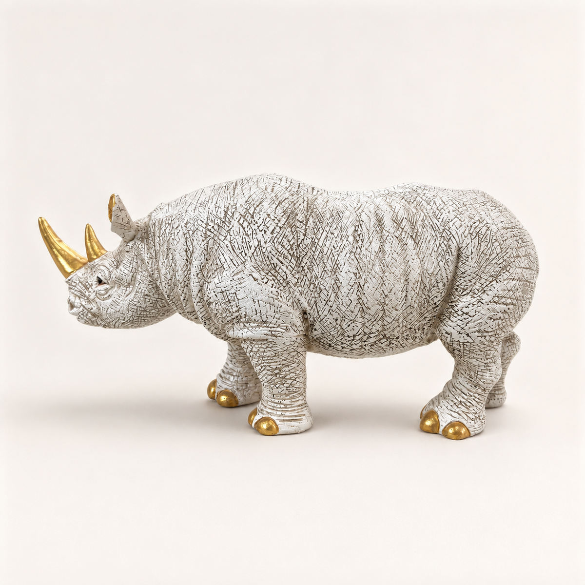 Ivory and gold decorative rhino sculpture, reverse side view
