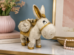 Antique ivory and gold traveller donkey sculpture styled on a console