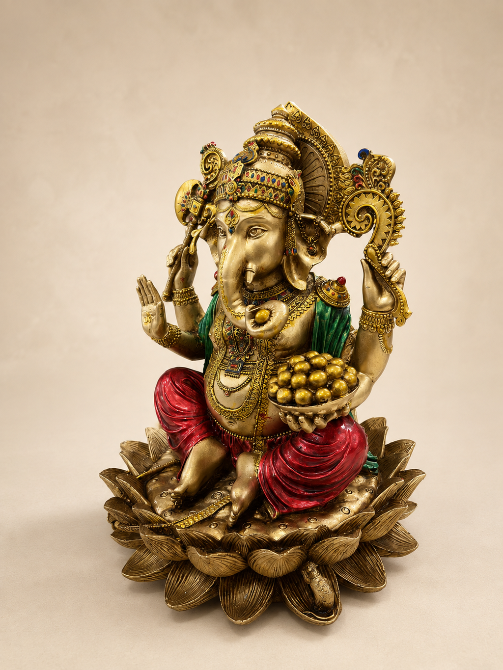 Angled view of the Ganesha idol showing the bowl of sweets, detailed jewellery and layered lotus pedestal